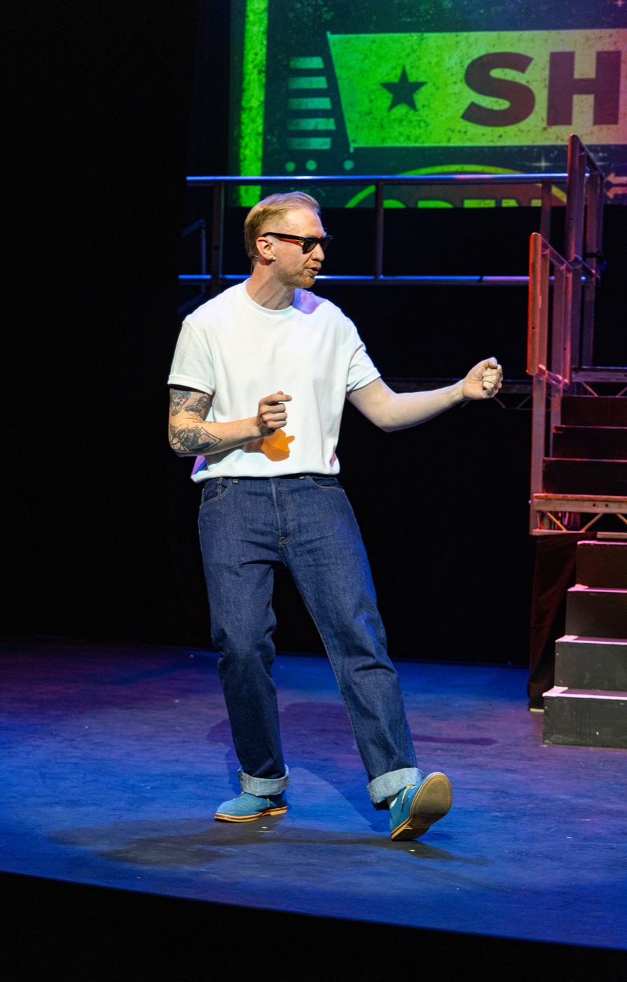 Jamie Edwardson performing on stage in sunglasses
